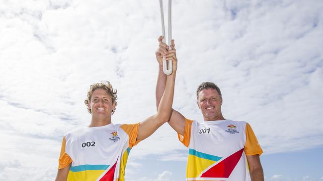 Hendy and son TJ carrying the Queen’s Baton in Surfers Paradise, ahead of the official start to the 2018 Gold Coast Commonwealth Games. Picture: Jerad Williams