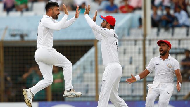 Afghanistan cricketer Rashid Khan (L) celebrates with his teammates after the dismissal of Bangladesh cricketer Musfiqur Rahim during the fourth day of the one-off cricket Test match between Bangladesh and Afghanistan at the Zohur Ahmed Chowdhury Stadium in Chittagong on September 8, 2019. Picture: STR / AFP.