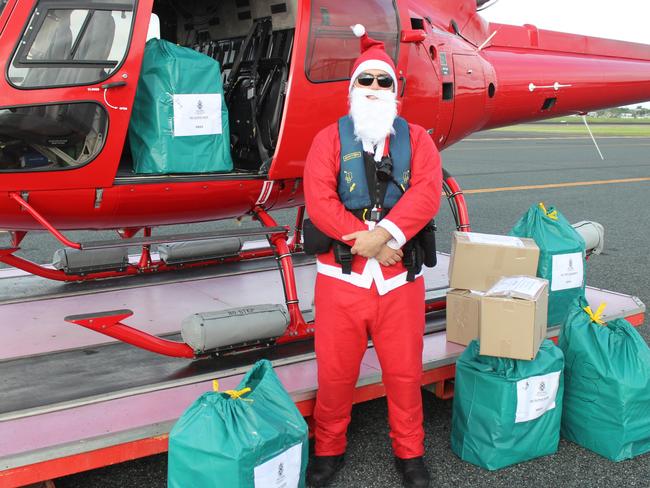 Santa (Charlie Densley of Auriga Aviation) was loading their helicopter with gifts. Stella Maris Seafarers Centre Mackay organised a Christmas gift drop to the international crews of bulk carriers anchored off Mackay. They delivered to four ships today (Friday, December 23, 2022). Picture: Andrew Kacimaiwai