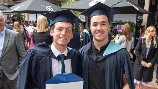 Harry Aycett and Lachlan Parkinson celebrate graduation. Picture: Brad Fleet