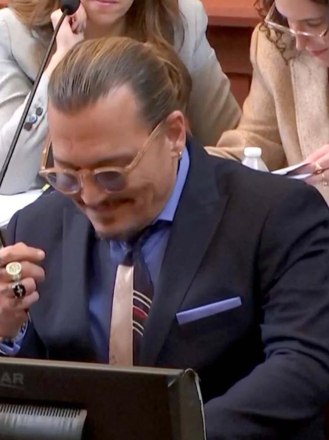 Johnny Depp laughs during Amber Heard’s testimony. Picture: Supplied