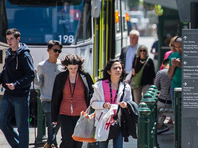 Possible redevelopment at the intersection of Flinders and Elizabeth Streets. Generic commuters and trams.