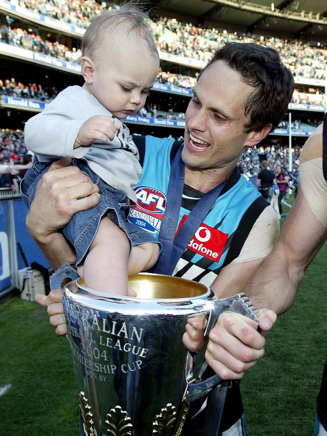 Gavin Wanganeen with his son Tex and the Premiership Cup in 2004. Picture: Cameron Tandy