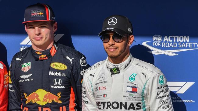 Red Bull's Dutch driver Max Verstappen (C), Ferrari's German driver Sebastian Vettel (L) and Mercedes' British driver Lewis Hamilton pose after taking the pole, second and third position respectively for the F1 Brazil Grand Prix in the qualifying session at the Interlagos racetrack in Sao Paulo, Brazil, on November 16, 2019. (Photo by Nelson ALMEIDA / AFP)