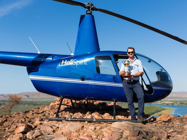 Kununurra helicopter pilot James Bondfield with the Emirates Melbourne Cup on Elephant Rock.