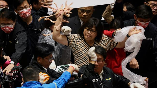 Taiwan lawmakers throw pork intestines at each other during a scuffle in the parliament in Taipei on November 27. Taiwan is a thriving democracy.