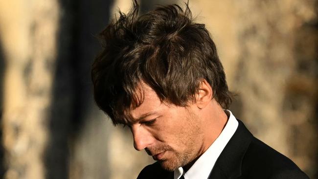 Former One Direction band member Louis Tomlinson leaves the funeral service.