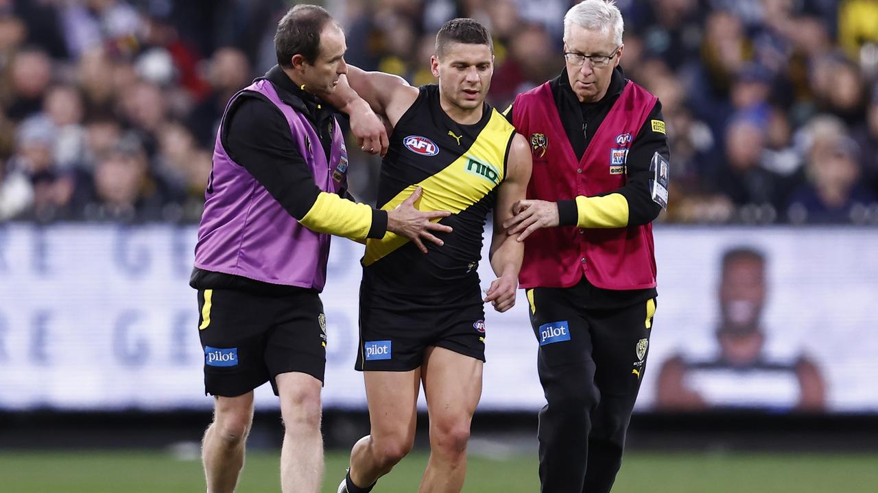 MELBOURNE, AUSTRALIA - JUNE 25: Dion Prestia of the Tigers is helped from the ground during the round 15 AFL match between the Geelong Cats and the Richmond Tigers at Melbourne Cricket Ground on June 25, 2022 in Melbourne, Australia. (Photo by Darrian Traynor/Getty Images)