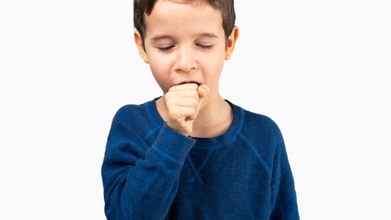 Young little boy kid wearing blue shirt standing over isolated background feeling unwell and coughing as symptom for cold or bronchitis.