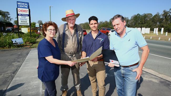 Residents Ruth Cordingley, Graham Bobermien, Stephen Sammut and Paul Casbolt on the main road through Logan Village, which they say will be widened to four lanes ruining the feel of their village. PHOTO: AAP Image/Jono Searle