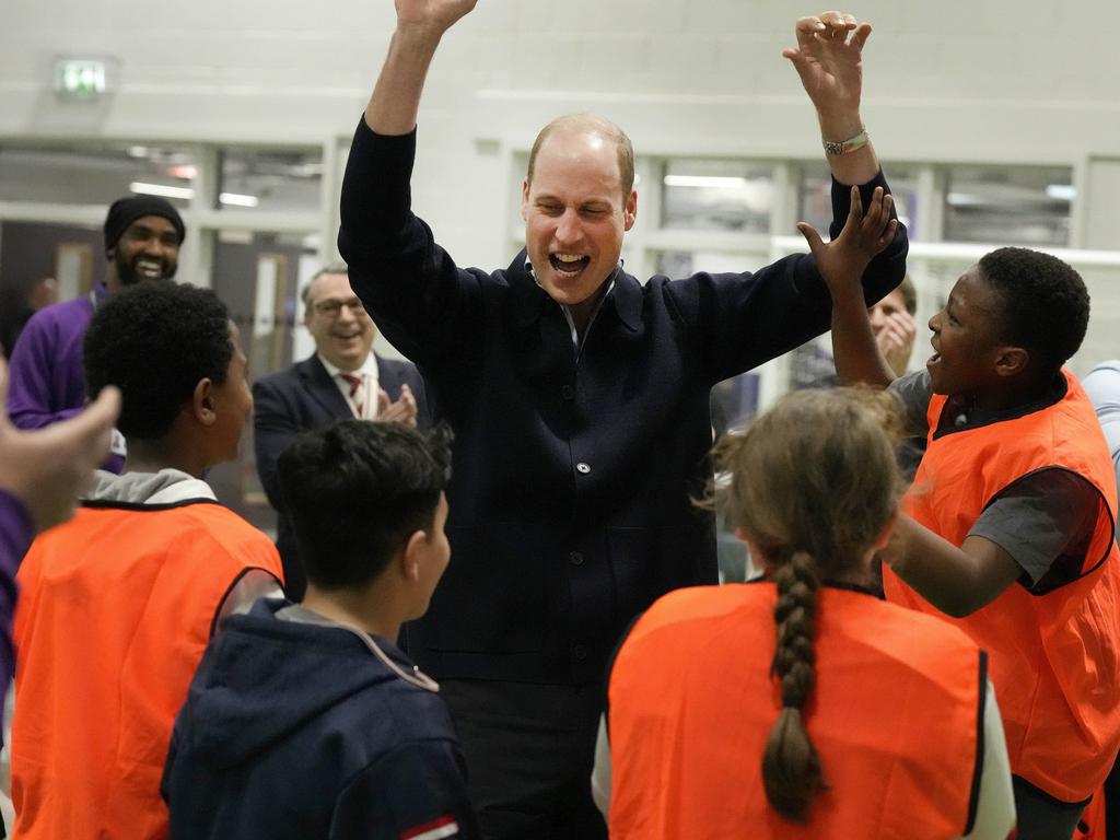 William celebrates with young people after he threw a basketball during his visit to WEST. Picture: Getty Images