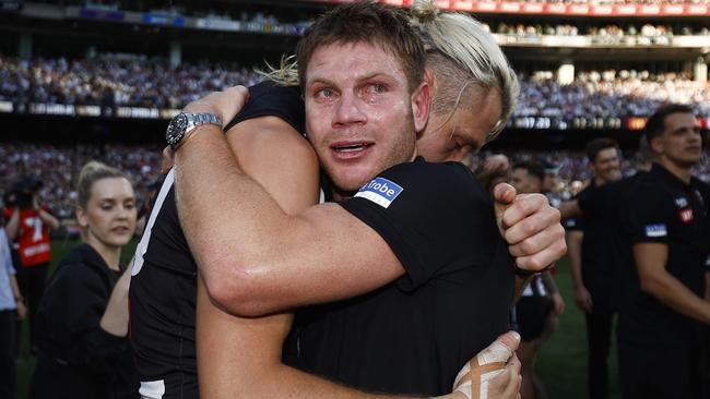 An emotional Taylor Adams was consoled by Collingwood skipper Darcy Moore after he missed out on the Magpies’ premiership win last month. Picture: Daniel Pockett / Getty Images