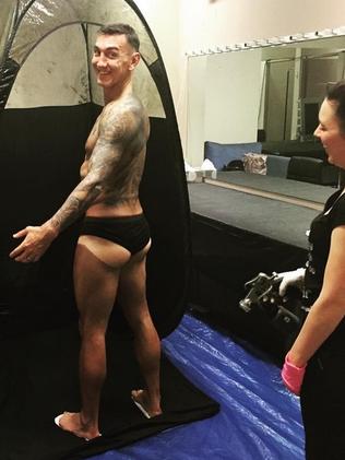 Finalist Mat Rogers receives a spray tan prior to DWTS. Picture: Emma Freedman