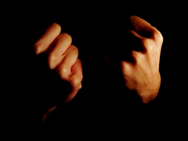 Generic image depicting anger. Two hands clenched in fists, silhouette.