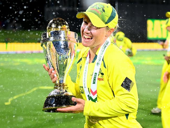 CHRISTCHURCH, NEW ZEALAND - APRIL 03: Alyssa Healy of Australia celebrates with the trophy after Australia won the 2022 ICC Women's Cricket World Cup Final match between Australia and England at Hagley Oval on April 03, 2022 in Christchurch, New Zealand. (Photo by Hannah Peters/Getty Images)