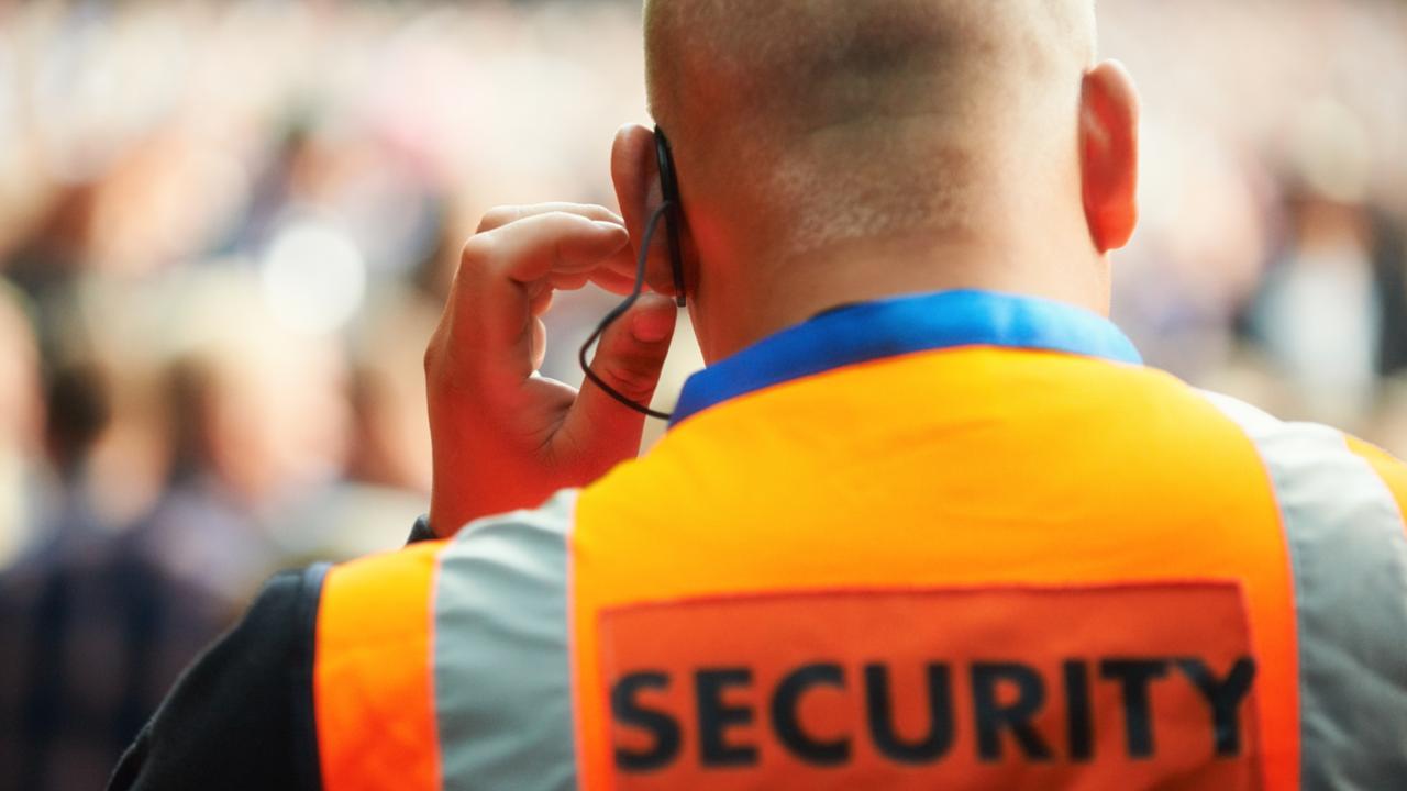 Rear view of a security guard listening to his headset. Generic photo of security guard.