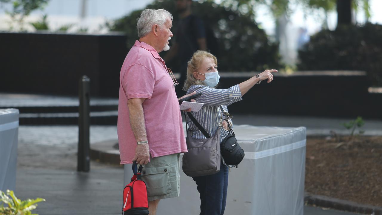 Some people took to wearing face masks as they ventured out into the smoke-filled air. Picture: Rohan Kelly