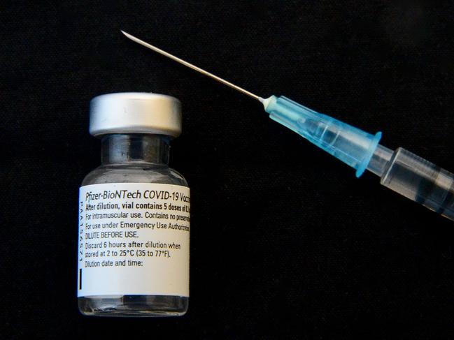 (FILES) A picture taken on January 7, 2021 shows a vial and a syringe of the Pfizer/BioNTech Comirnaty Covid-19 vaccine at the Bordeaux CHU hospital. - Sanofi will help Pfizer and BioNTech to produce their Covid-19 vaccine and should package more than 100 million doses for the European Union by the end of 2021, the general manager of the French laboratory announced on January 26, 2021 in an interview with Le Figaro. (Photo by MEHDI FEDOUACH / AFP)