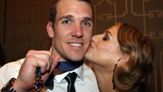 Dane Swan shows off his Brownlow Medal in 2011 with girlfriend Taylor Wilson.