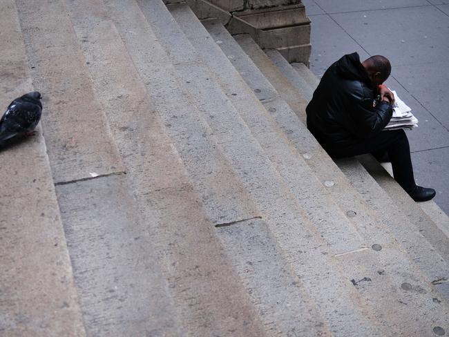 A man pauses along stairs near Wall Street. Picture: Getty