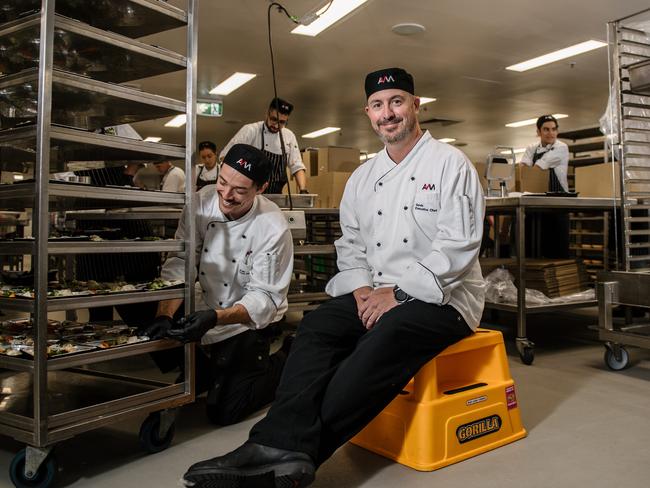 Josh McDonald working and Executive Chef Gavin Robertson from the Adelaide Convention Centre kitchen, who are putting their chefs to work to make up to 10,000 meals a day for our most vulnerable for meals on wheals in Adelaide, Friday, April 3, 2020. (AAP Image/ Morgan Sette)