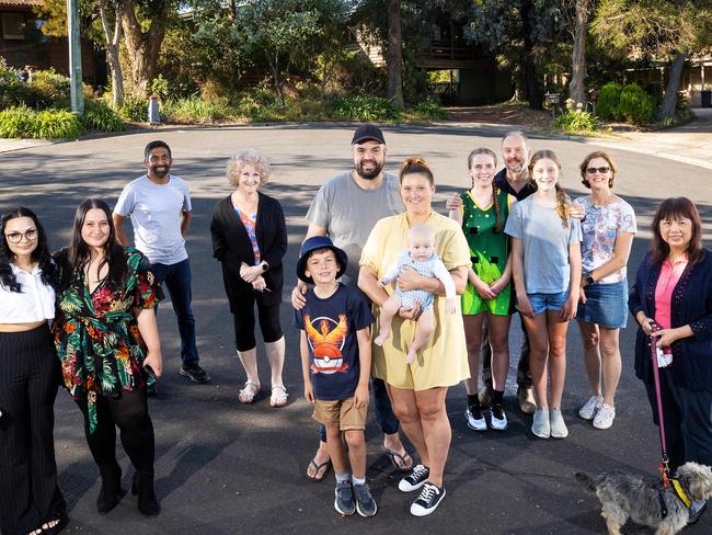 MELBOURNE, MARCH 26, 2022: Residents of Morrison Court, Mount Waverley ahead of the 2022 Federal Budget. L to R Jaida Kelso and Tia Devenport, Dilesh Weersuriya, Lynn cooper, Richard Knight and Sophie Hampton with their children Max, 7, and Noah, 5 months, Mark and Fiona Bahr with daughters Charlotte, 19, and Samantha, 14, and Winnie Lock.  Picture: Mark Stewart