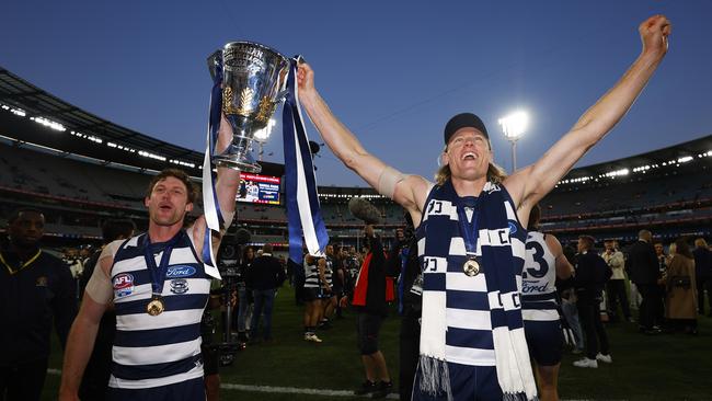 Jed Bews with Mark Blicavs after Geelong won the 2022 AFL premiership. Picture: Daniel Pockett/AFL Photos/via Getty Images.