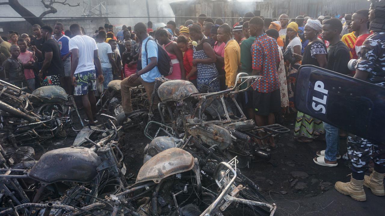 A pile of burnt motorbikes were left strewn in one street. Picture: Saidu BAH / AFP.