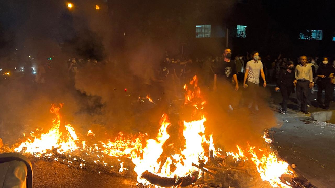 Demonstrators gather near a motorbike on fire during a protest for Mahsa Amini in Iran. Picture: AFP