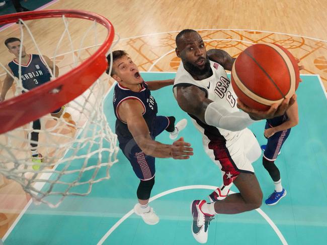 LeBron James drives to the hoop. Picture: Mark Terrill / AFP