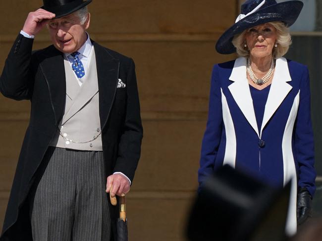 Britain's King Charles III and Britain's Camilla, Queen Consort arrive to meet the guests attending the Garden Party at Buckingham Palace, in London, on May 3, 2023 to celebrate their coronation ceremony as King and Queen of the United Kingdom and Commonwealth Realm nations, on May 6, 2023. (Photo by Yui Mok / POOL / AFP)