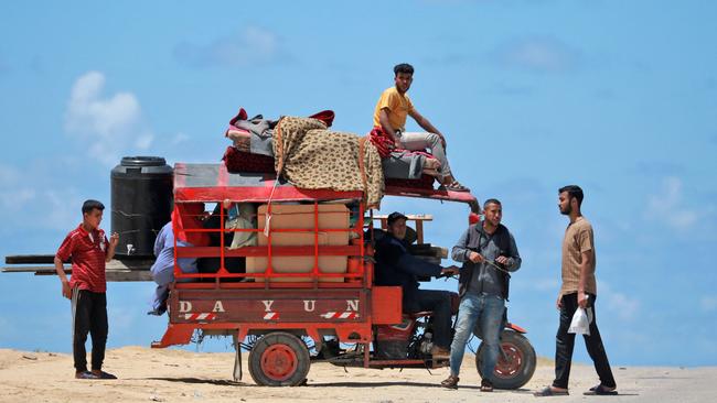 Displaced Palestinians who left with their belongings from Rafah in the southern Gaza Strip, following an evacuation order by the Israeli army, arrive to Khan Younis on Monday. Picture: AFP