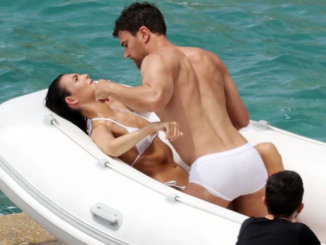 The pair were both pictured in white swimsuits as they got hot and heavy aboard a speedboat. Picture: Cobra Team/BACKGRID