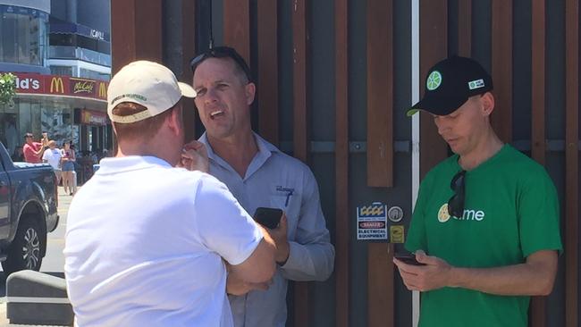 Council officials speak with Lime Director of Government Affairs Mitchell Price following the launch of the e-scooters on the Esplanade at Surfers Paradise today.