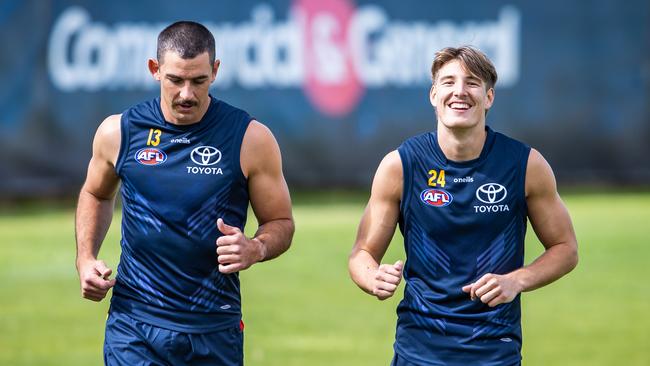 Josh Worrell (right) with Taylor Walker at Crows training. Picture: Tom Huntley