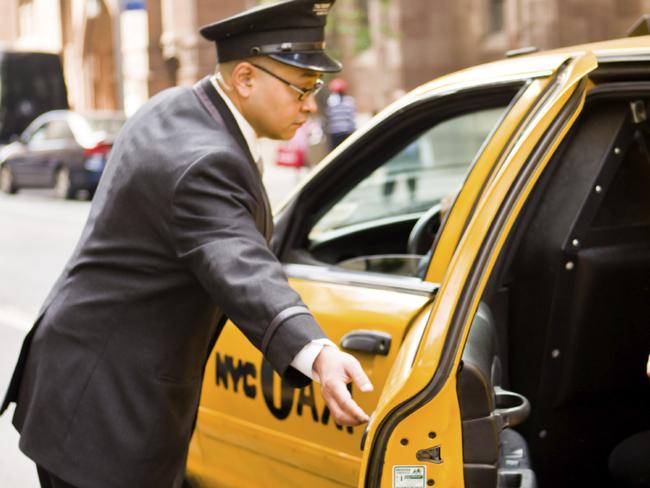 ESCAPE: TIPPING IN AMERICA .. Doorman opening taxi arriving at New York Hotel. Picture: iStock