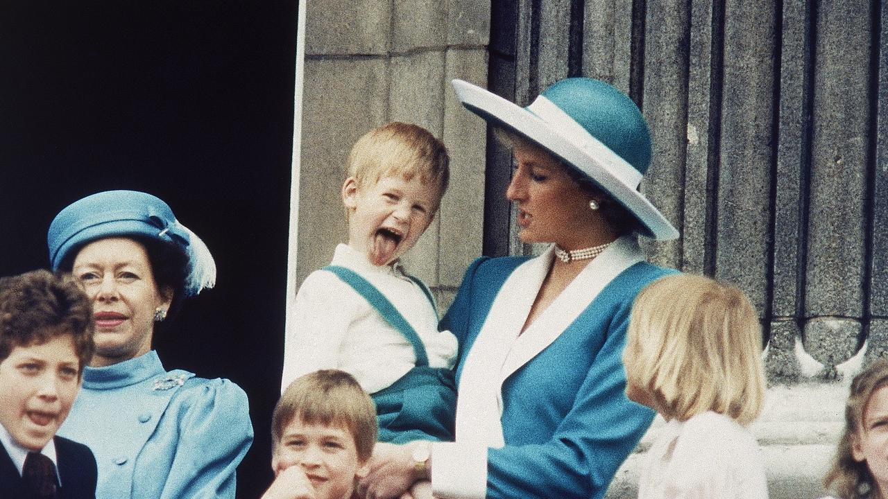 Prince Harry sticks out his tongue for the cameras on the balcony of Buckingham Palace. Picture: AP Photo/Steve Holland