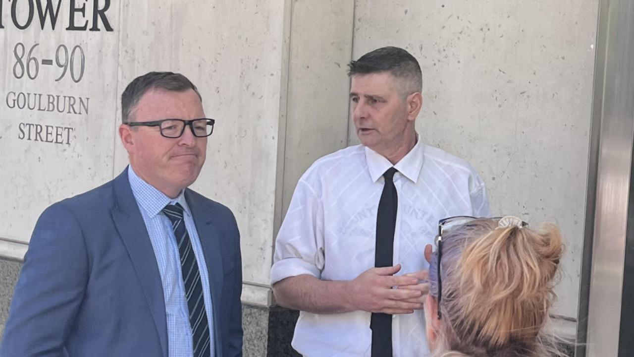 Simon Davies’ victim Glen Fisher (white shirt) speaks with supporters outside court on Tuesday. Picture: Steve Zemek/NCA Newswire.