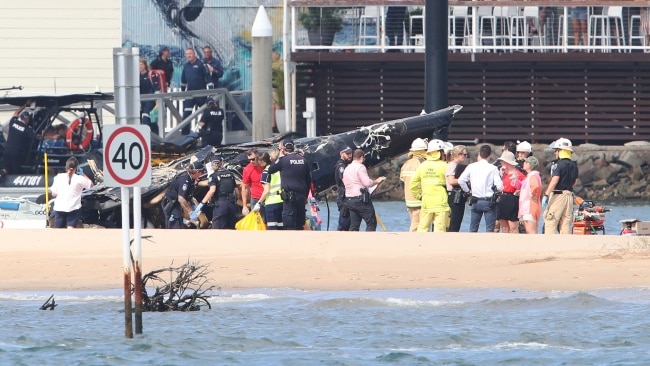 Emergency services at the scene of a helicopter crash between two Seaworld Helicopters. Picture: Glenn Hampson