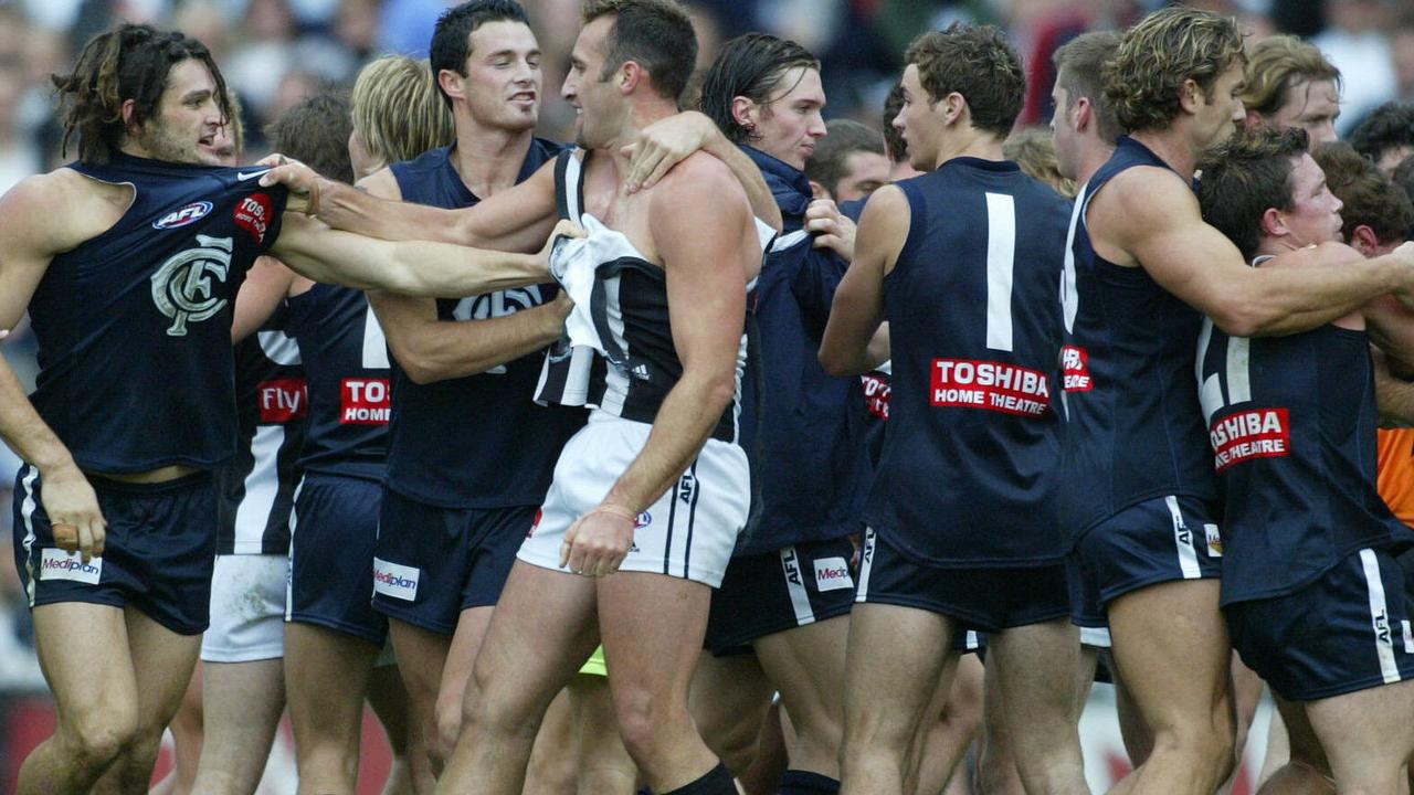 Anthony Rocca (torn jumper) wrestles with Carlton's Brendan Fevola in the middle of the brawl between Collingwood and Carlton in 2004.