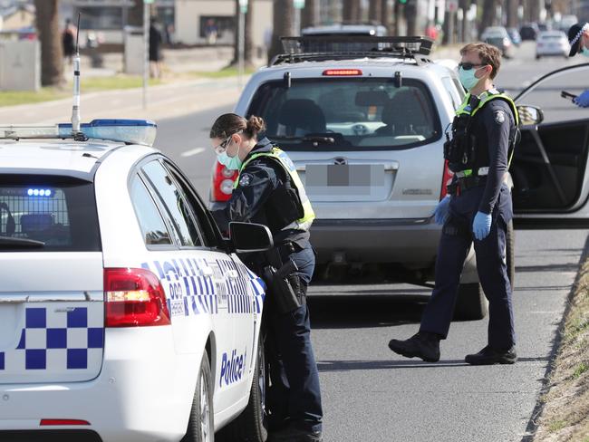 MELBOURNE, AUSTRALIA- NewsWire Photos SEPTEMBER 1, 2020: Police conduct roadside checks in Middle Park on he first day of spring as people are seen exercising along the foreshore during a stage four COVID-19 lockdown in Melbourne. Picture: NCA NewsWire/ David Crosling