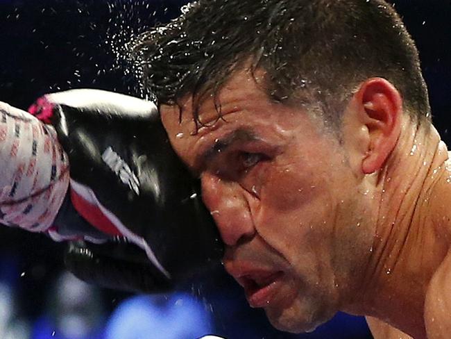 NEW YORK, NY - JUNE 07: Miguel Cotto of Puerto Rico lands a left punch to the face of Sergio Martinez of Argentina during the sixth round of the WBC Middleweight Championship fight on June 7, 2014 at Madison Square Garden in New York City. Cotto won by a TKO in the ninth round. Rich Schultz/Getty Images/AFP == FOR NEWSPAPERS, INTERNET, TELCOS & TELEVISION USE ONLY ==