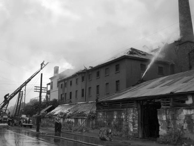 28/11/1951 Fire Hutchins boarders residence, Collins Street, Hobart, Tasmania Fire Service (TFS) 1913 Leyland truck carrying a 70 (seventy) foot turntable ladder, Hobart’s first motor fire engine, in action for the last time Negative Number A4036/1