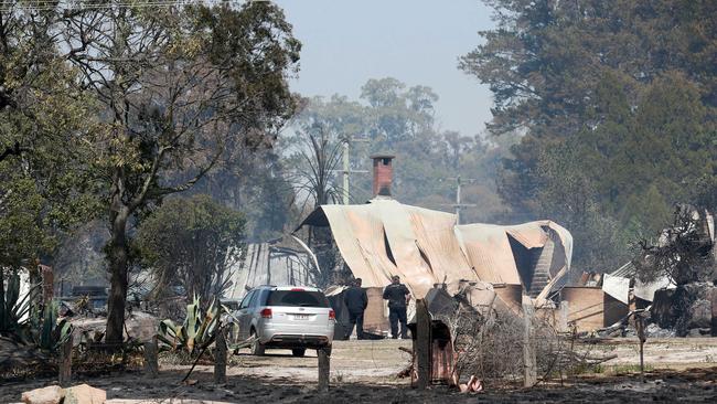 Police survey the damage on Caves Rd, Stanthorpe. Picture: AAP/Image Sarah Marshall