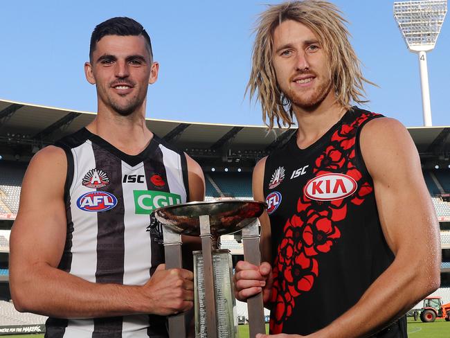 Collingwood captain Scott Pendlebury and Essendon captain Dyson Heppell with the Anzac Day trophy on the MCG .      . Pic: Michael Klein