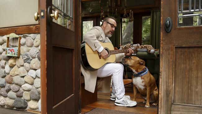 Colin Hay at home in Topanga Canyon, California in April 2020, serenading his dog Rico. Picture: Danny Moloshok