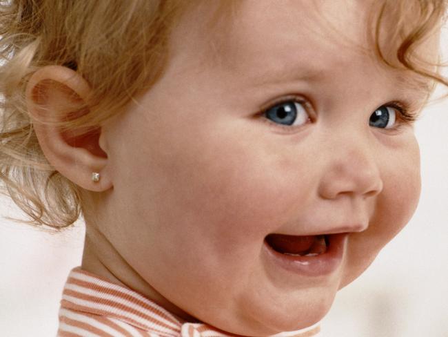 Infant Wearing a Striped Top Playing with Toys