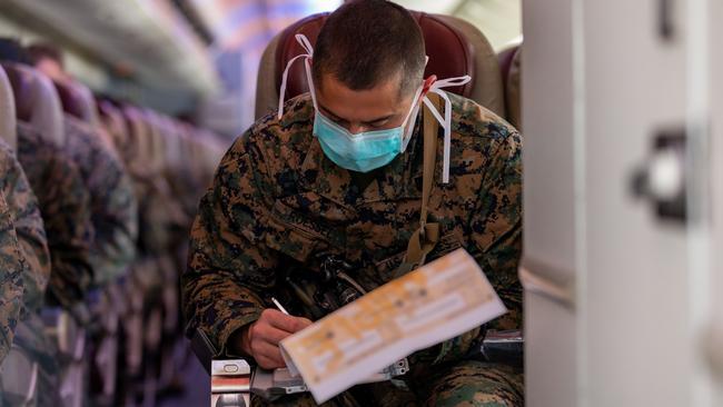 A United States marine completes Australian border entry forms prior to his arrival at RAAF Base Darwin, Northern Territory, as part of Marine Rotational Force Darwin