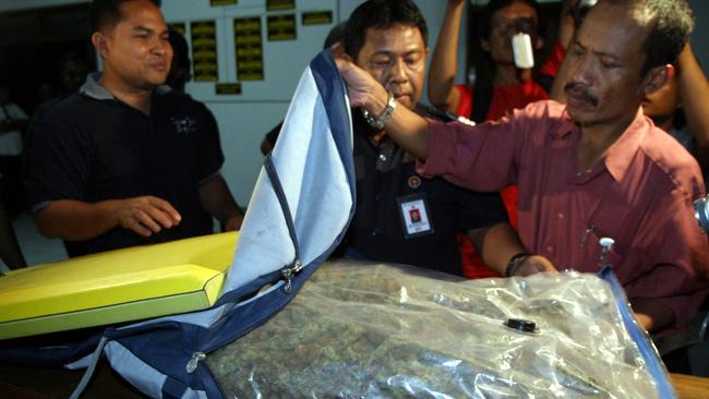 Customs officers examine the 2.4 kilograms of marijuana seized.