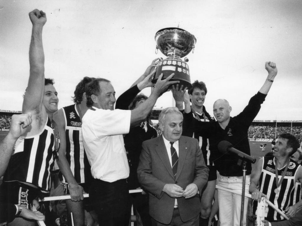 SANFL president Max Basheer on the podium with football coach John Cahill and players after the 1990 match. Picture: Russell Millard